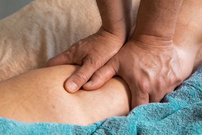 Patient's lower leg receiving massage treatment